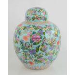A Chinese porcelain ginger jar and cover decorated in a famille rose floral design with decorative