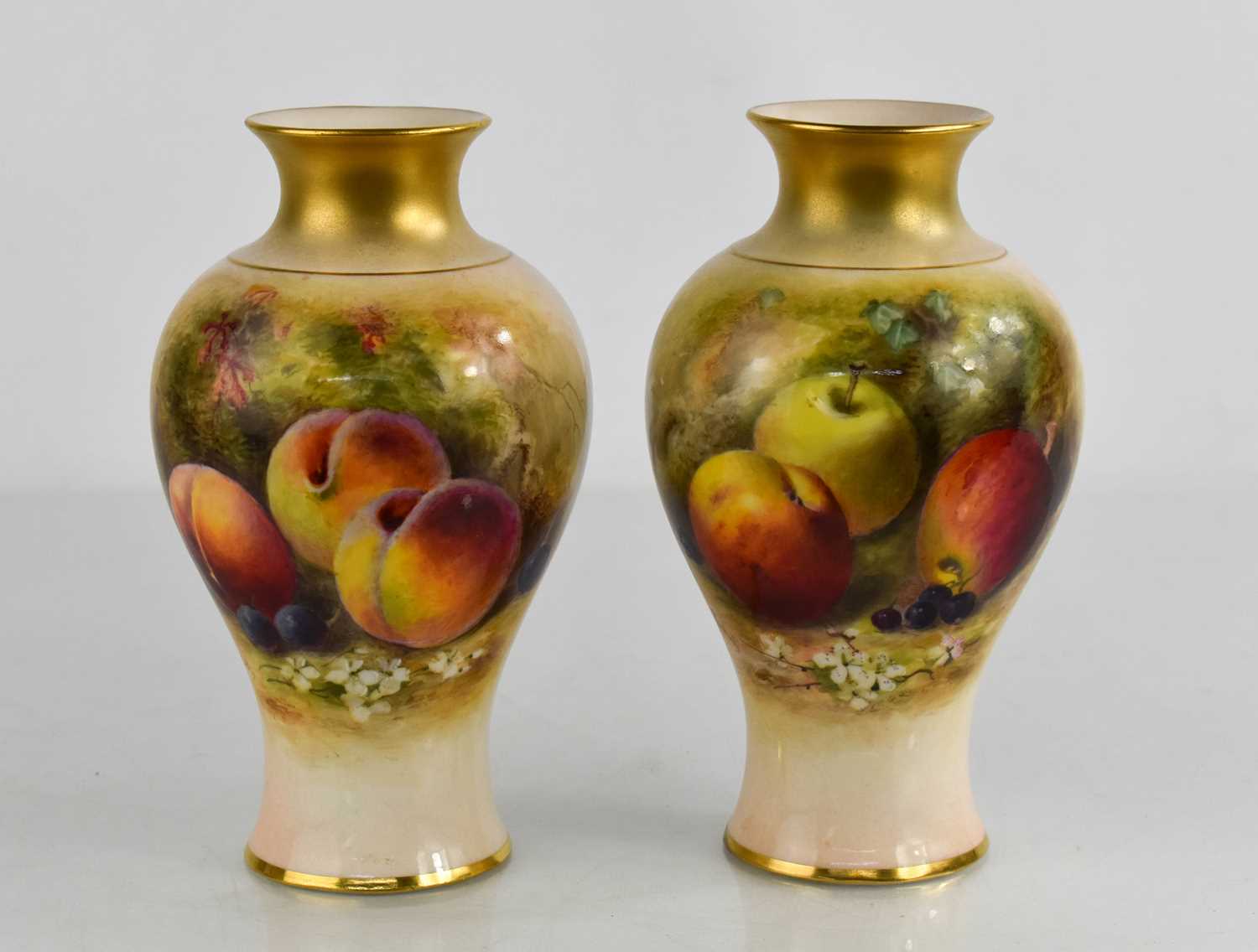 A pair of Royal Worcester vases by Rickets, painted with apples and peaches on a mossy ground,