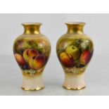 A pair of Royal Worcester vases by Rickets, painted with apples and peaches on a mossy ground,