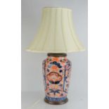 A large Imari vase converted to a table lamp with shaped cream silk shade, 63cms tall including