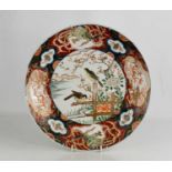 A 19th century Japanese charger, with enamelled polychrome decoration, with birds to the centre,