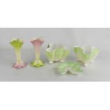 A pair of Royal Worcester spill vases, in green and pink tint with leaf form feet, together with a