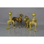 A group of brass items, comprising a pair of fire dogs, with ball and claw finials, a greyhound,