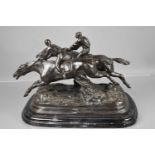 A 20th century bronze sculpture, two racehorses & jockeys jumping the last fence, raised on a marble