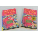 Two Harry Potter and the Philosopher's Stone books, one is 1st edition, 31st printing
