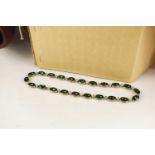 A group of vintage ladies hats together with a emerald style necklace set in metal