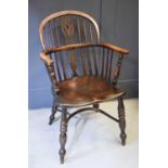 A 20th century yew wood Windsor chair, with crinoline stretcher.