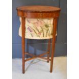 A 19th century satinwood oval sewing table, with tapestry basket, with square tapered lets, 19 by 13