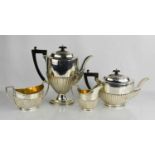 A silver tea service, Sheffield 1910, comprising tea pot, hot water pot, milk jug and sugar bowl,