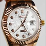 A Rolex style rose gold coloured wristwatch.