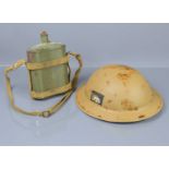 A WWII era British desert Brodie helmet and liner dated 1938 together with a water canteen