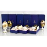 A group of six Royal Crown Derby Faberge eggs on stand including two commissioned by Wheelers of