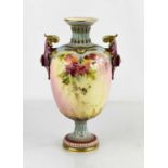A Royal Worcester pedesal vase, decorated with flowers, with a pair of purple handles and foot,