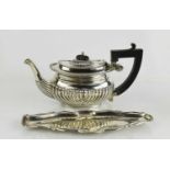 A silver 19th century tea pot, Chester 1902, together with a silver dish, with decorative scroll