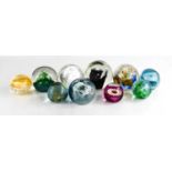 A group of eight Caithness and other paperweights, of various form and design.