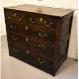An 18th century oak chest of drawers with planked top and two over three long graduated