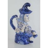 A 19th century Dutch Delft blue and white character jug of Mr. Punch, with tassel hat cover,