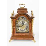 A Warmink Wuba walnut cased mantle clock with acorn finials, moon phase and Roman numerals raised on