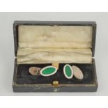 A pair of silver and green enamelled oval form cuff links, in presentation case