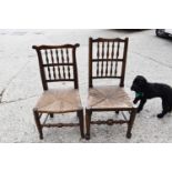 Two 19th century Lancashire spindleback elm and oak chairs, rush seats