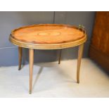 An Edwardian mahogany oval centre table, with detachable brass handled tray with fan inlay, the base
