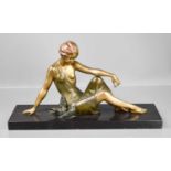 An Art Deco spelter figure of a woman beside doves, raised on a slate plinth signed Godard, 28 by 53