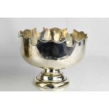 A silver bowl, with shaped rim, Birmingham 1909, with a lead weighted base, 18cm diameter,