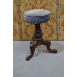 An Edwardian piano stool upholstered in blue velvet