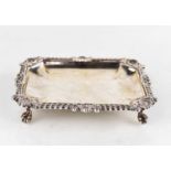 An Asprey silver dish with gadrooned rim and foliate motifs raised on four feet, Birmingham 1989,