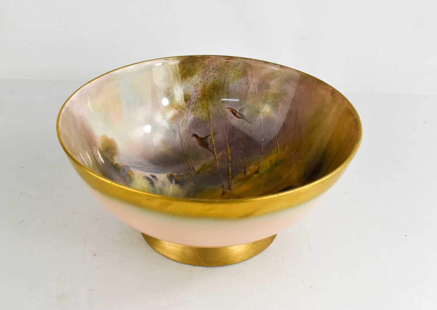 A Royal Worcester bowl, by JAS Stinton, painted with five pheasants, in a wooded landscape, date