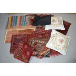 A quantity of small rugs including two striped kelims with central motif, two silk rugs, one with