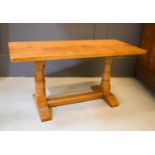 A Wilf Hutchinson 'Squirrelman' oak coffee table with adzed top, trestle base, and turned end