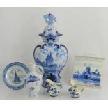 A quantity of Delft ware to include a Herman Jansen flagon, tile, plate, vase and cover and other