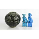 Two blue glazed pottery Chinese dogs of fo, together with a Chinese ovoid vase decorated with peonie