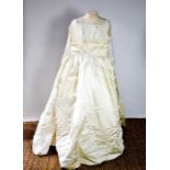 A silk and lace vintage wedding dress, with long sleeves.