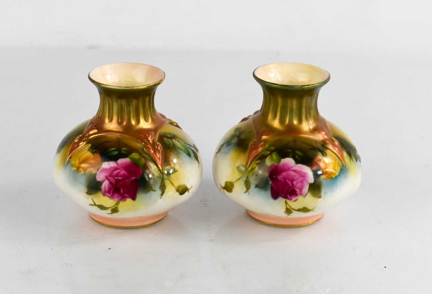 A pair of Royal Worcester vases painted with roses, circa 1900, 4ins high.