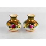 A pair of Royal Worcester vases painted with roses, circa 1900, 4ins high.