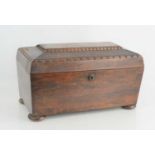 An antique rosewood tea caddy raised on bun feet16.5cm high by 32cm wide by 17cm