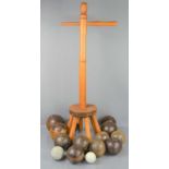 A group of late 19th/early 20th century wooden bowling balls, together with a washing dolly stool.