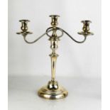 A silver candleabra, with three branches and weighted base, the three branches separate from the