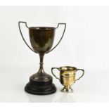 Two silver trophies, one raised on an ebonised plinth, both engraved with presentation inscriptions,