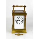 A French brass carriage clock, with Roman numeral dial flanked by columns, with key, 15cm high.