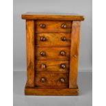 A Victorian walnut miniature / table top Wellington chest, with five drawers and turned handles,