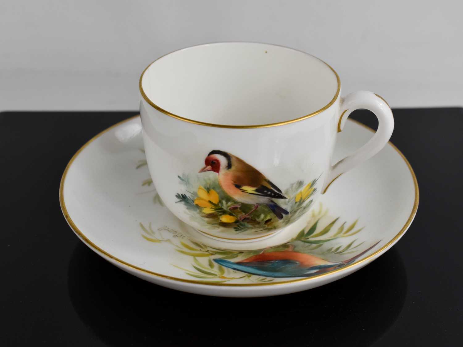 A Royal Worcester tea cup and saucer, by Powell, the cup painted with a Goldfinch, the saucer with a