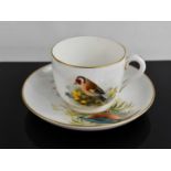 A Royal Worcester tea cup and saucer, by Powell, the cup painted with a Goldfinch, the saucer with a