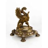 A silver plated griffin centrepiece, the finely modelled griffin with paw raised upon an oval base