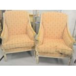 A pair of 20th century French armchairs, with painted and gilded decoration, with scroll backs and