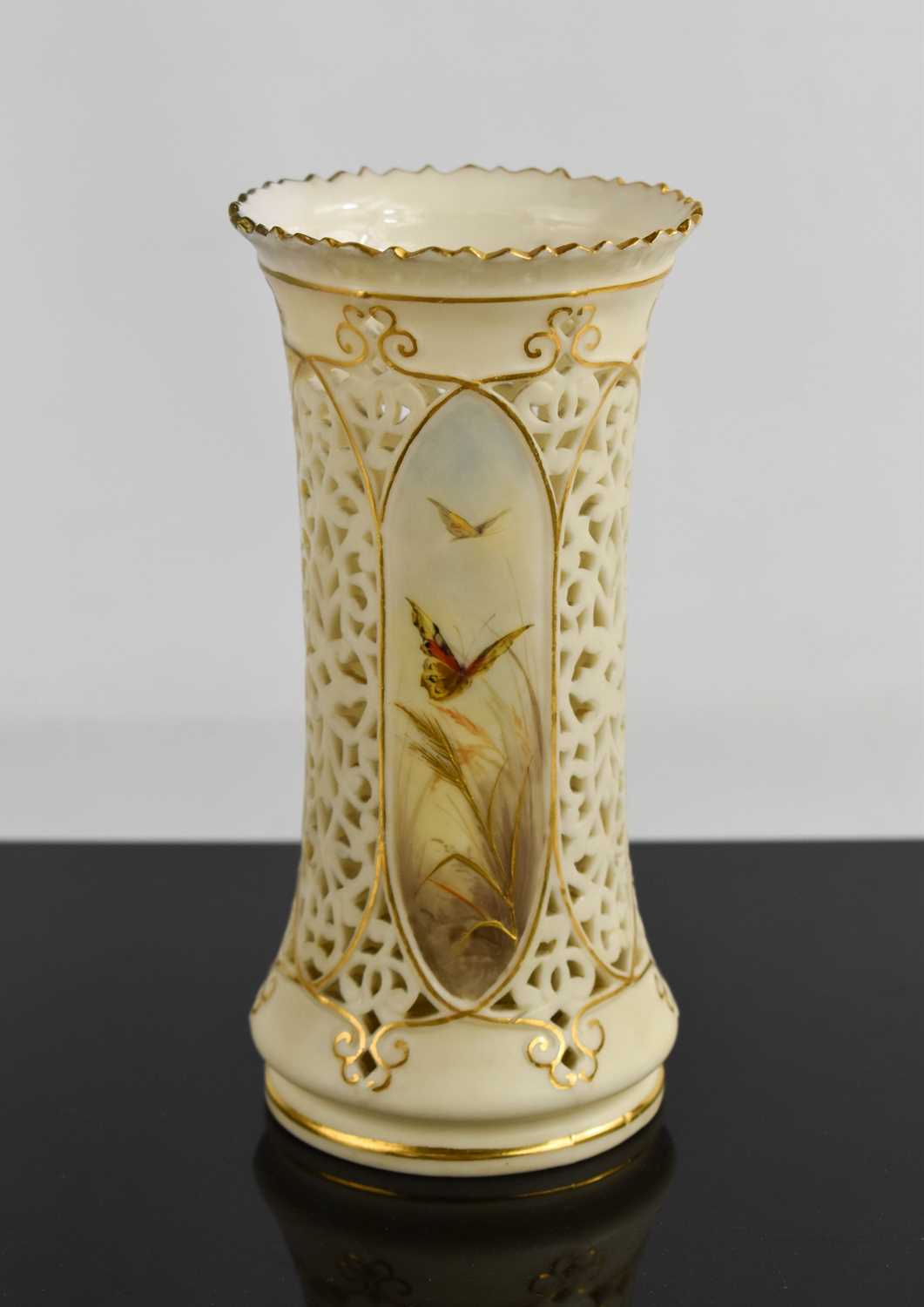 A 19th century Royal Worcester ivory vase with pierced decoration, with three panels painted with