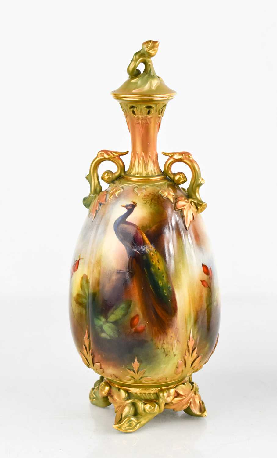 A Royal Worcester vase, by Henry Martin, with twin handles and cover, painted with peacock in