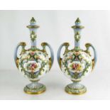 A pair of Royal Worcester vase and covers, circa 1902, of ovoid form, with scroll handles and